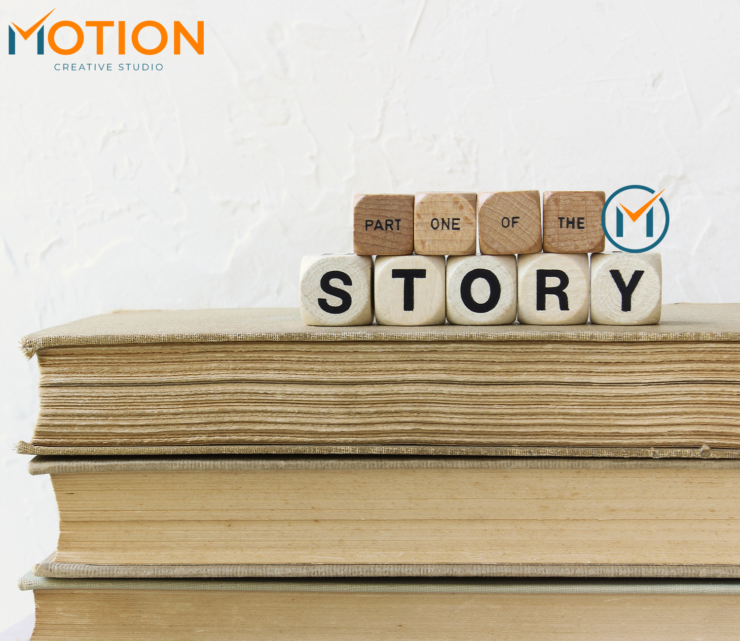 Stack of books with the word STORY spelled out on wooden blocks, symbolizing brand storytelling in marketing